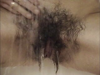 Very hairy Inge enjoys a shower after sport