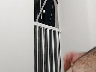 wank with cumshot in front of the apartment window