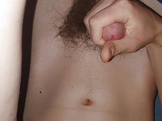 Teen masturbates and cums on his belly and navel
