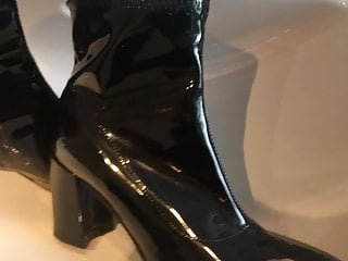 Pissing on black patent ankle boots