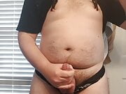 Fat boy wearing a thong and clamps rubs his little cock