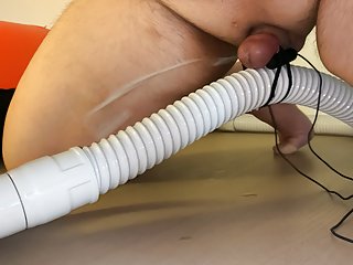 Small Penis With Vibrator Eggs Holding A Vacuum Hose