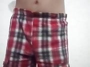 Slender boy undresses in front of the camera