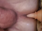 lying in bed and riding a dildo and jerking off my cock