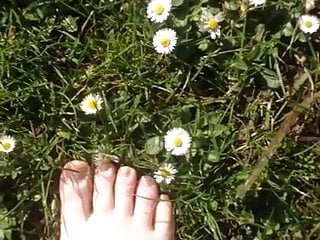 Walking on the grass and daisies showing my feet