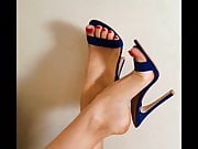 Beautiful feet in blue sandals and red enamel