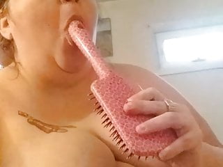 Piggy cleaning sucking off hairbrush handle...