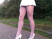 Public road walking in white hose and pleated skirt.